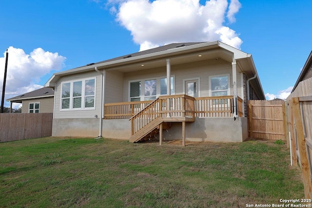 rear view of property featuring a lawn