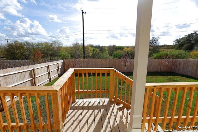 wooden terrace featuring a lawn