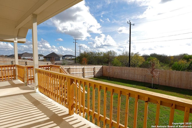 wooden terrace featuring a lawn