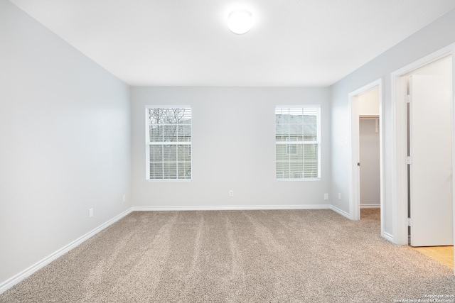 empty room featuring light carpet and plenty of natural light