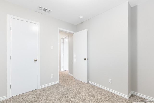 unfurnished bedroom with light carpet