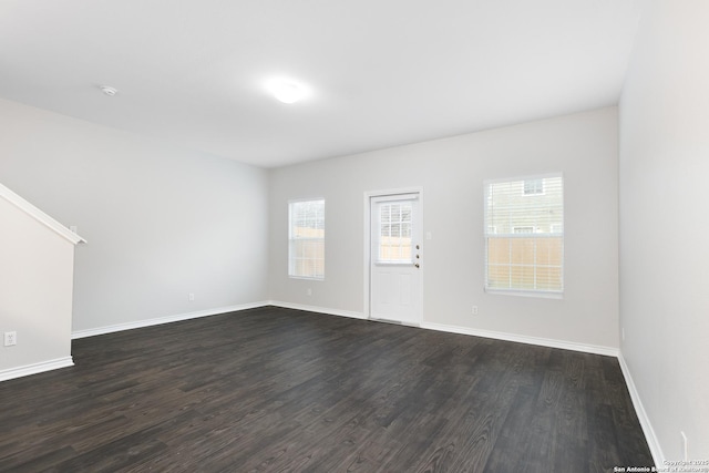 spare room with dark hardwood / wood-style floors