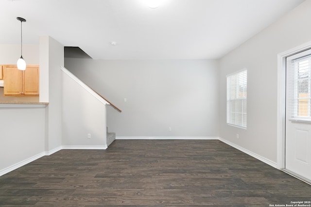 unfurnished living room featuring dark hardwood / wood-style flooring