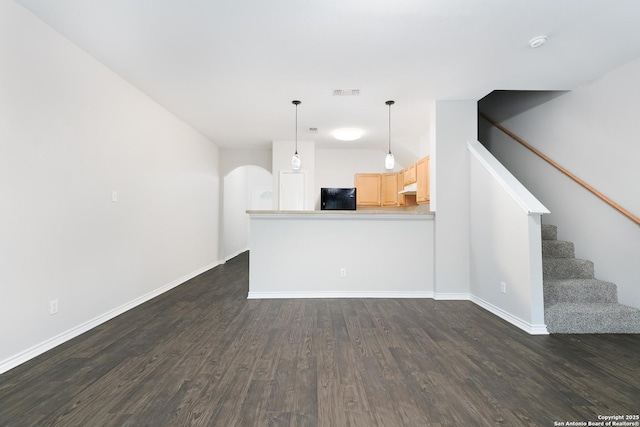 unfurnished living room featuring dark hardwood / wood-style flooring