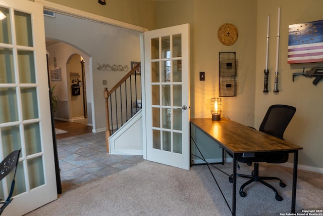 carpeted home office with french doors