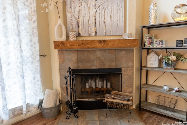 interior details featuring a tile fireplace