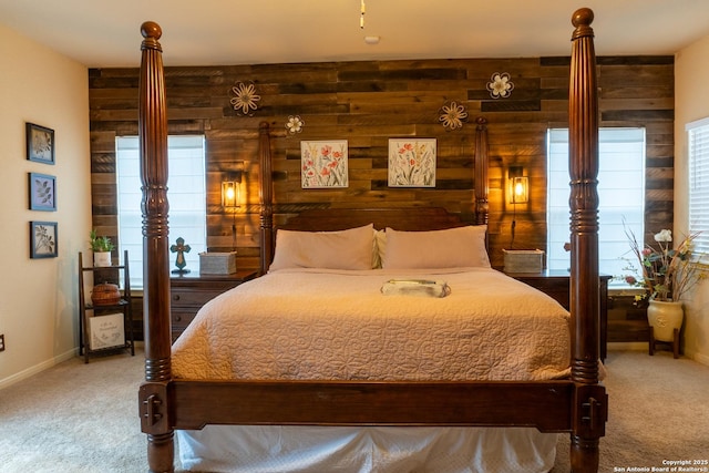 bedroom featuring carpet floors and wooden walls