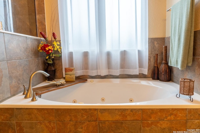 bathroom featuring tiled tub