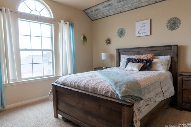 bedroom with light carpet and lofted ceiling