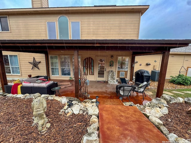 rear view of house with an outdoor hangout area and central air condition unit