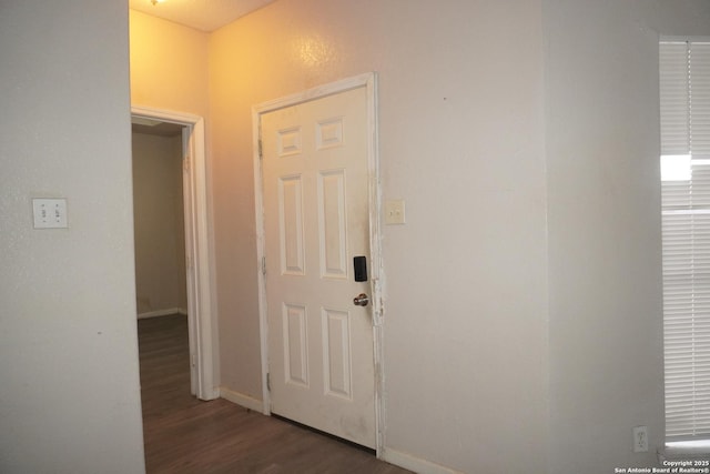 hallway with dark hardwood / wood-style floors