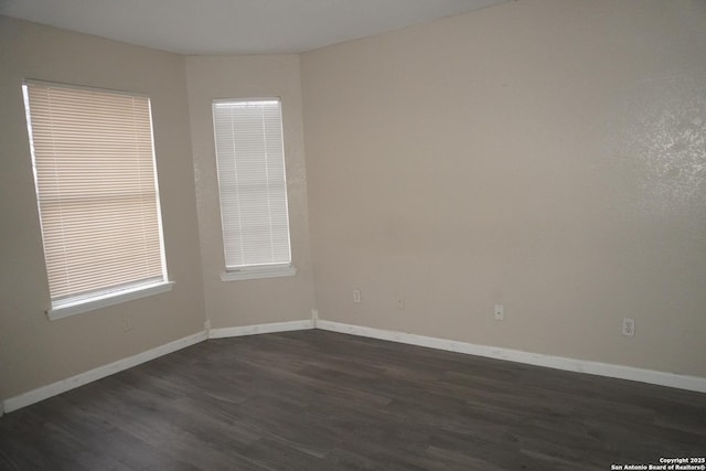 unfurnished room featuring dark hardwood / wood-style floors