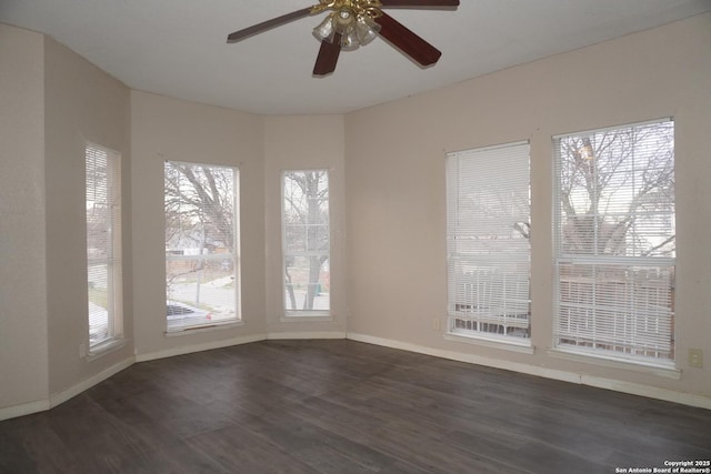 spare room with ceiling fan and dark wood-type flooring