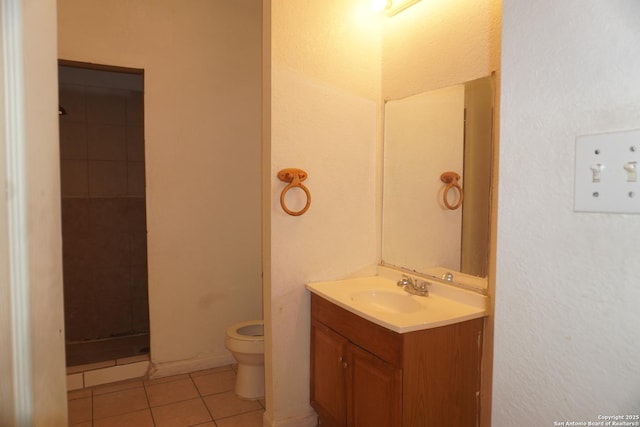 bathroom featuring toilet, vanity, and tile patterned floors