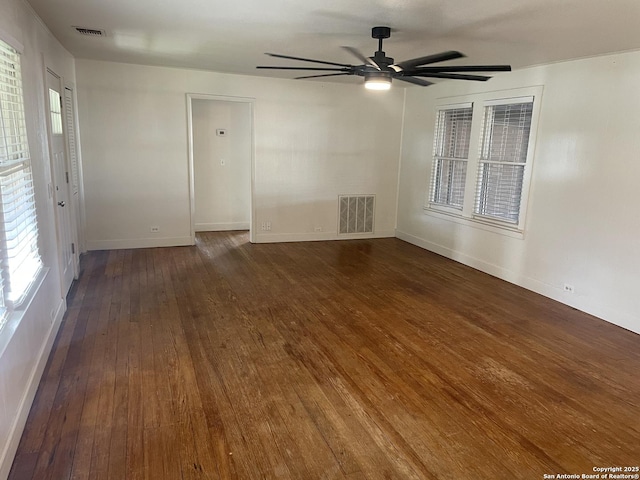 spare room with ceiling fan and dark wood-type flooring