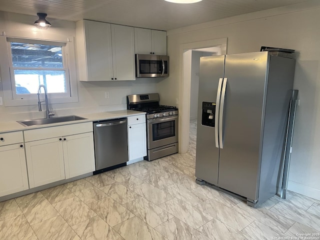 kitchen with white cabinetry, sink, and appliances with stainless steel finishes