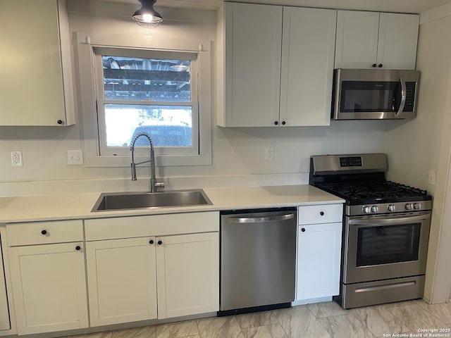 kitchen with white cabinetry, sink, and appliances with stainless steel finishes