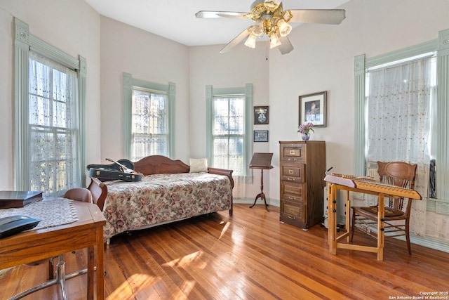 bedroom with ceiling fan and light wood-type flooring