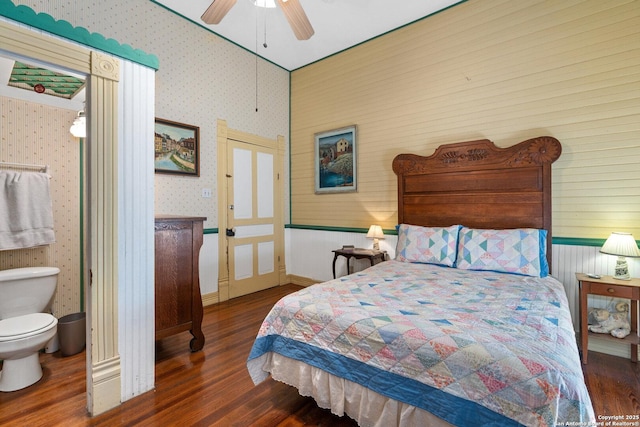 bedroom with dark hardwood / wood-style flooring and ceiling fan