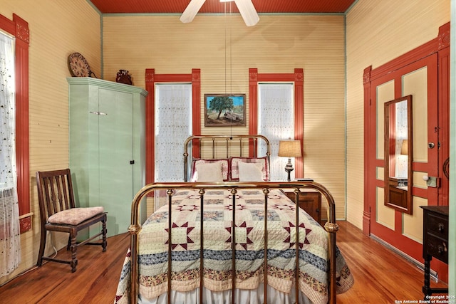 bedroom with ceiling fan and wood-type flooring