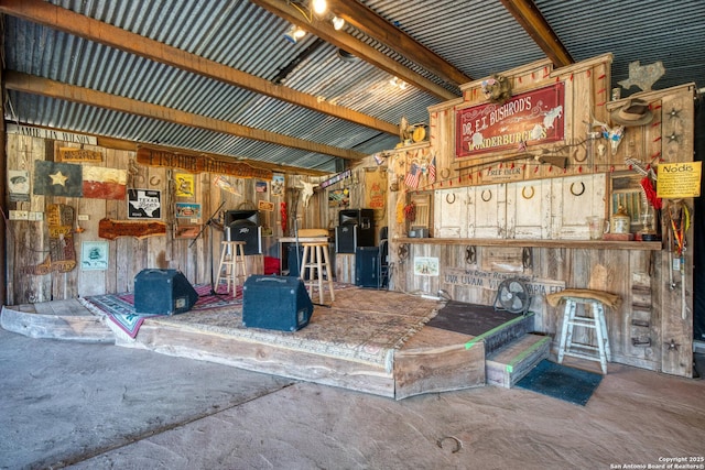 miscellaneous room with lofted ceiling and concrete flooring