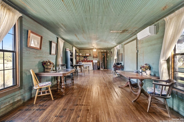 sunroom with an AC wall unit and ceiling fan