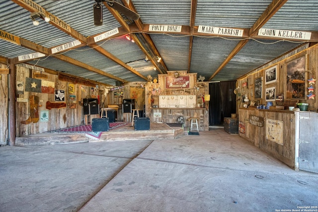 misc room featuring lofted ceiling and concrete floors