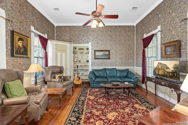 living room with crown molding, ceiling fan, and hardwood / wood-style flooring