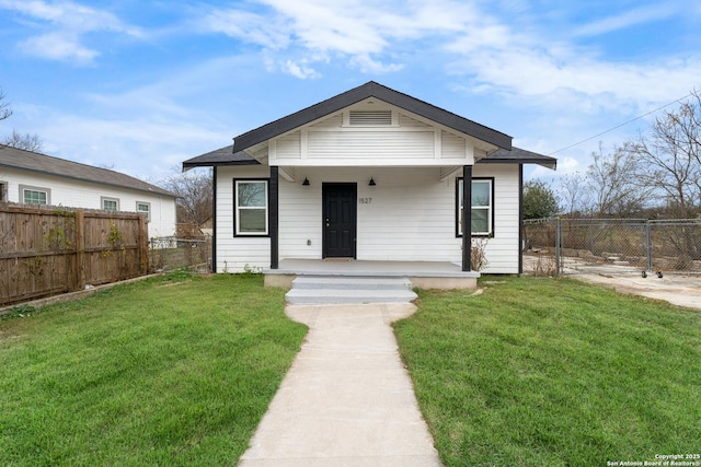 bungalow-style home with covered porch and a front lawn