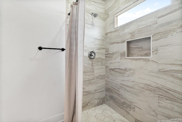 bathroom with a tile shower