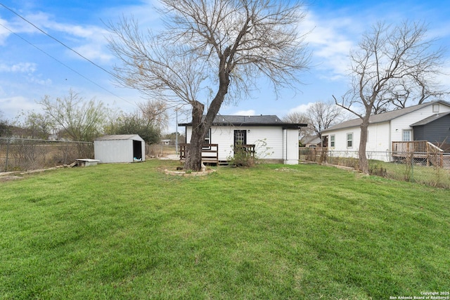 view of yard with a wooden deck and a shed