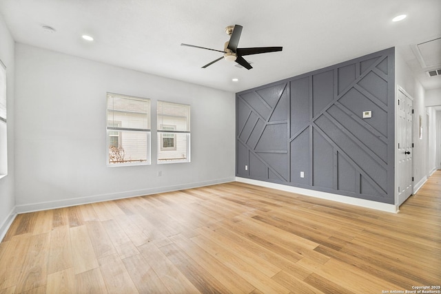 spare room featuring light hardwood / wood-style flooring and ceiling fan