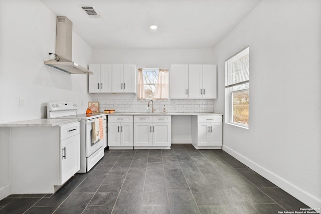 kitchen featuring sink, wall chimney exhaust hood, tasteful backsplash, electric stove, and white cabinets