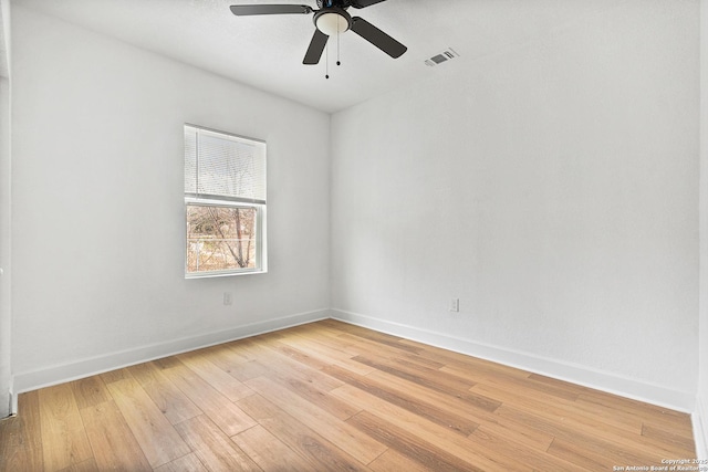 empty room featuring ceiling fan and light hardwood / wood-style flooring