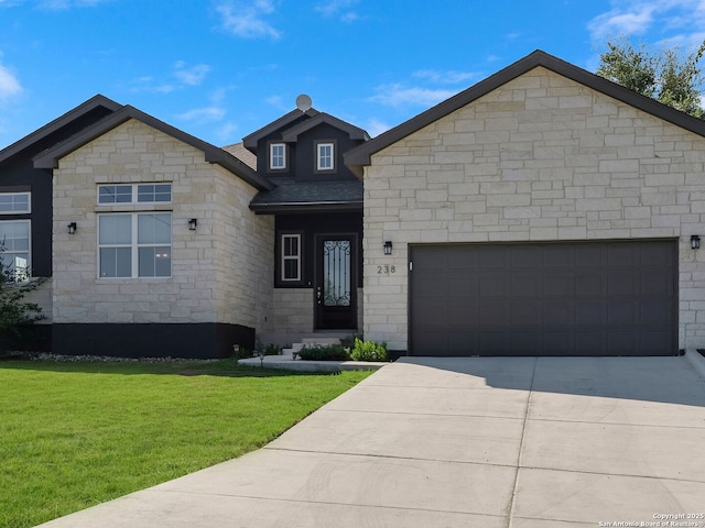 view of front of house featuring a front lawn and a garage