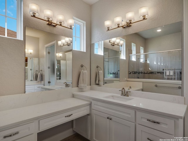 bathroom featuring a shower and vanity