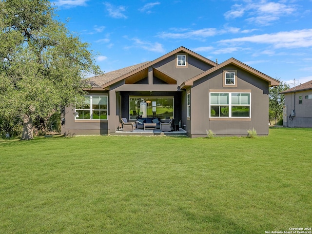 back of property featuring a yard, a patio, and an outdoor hangout area