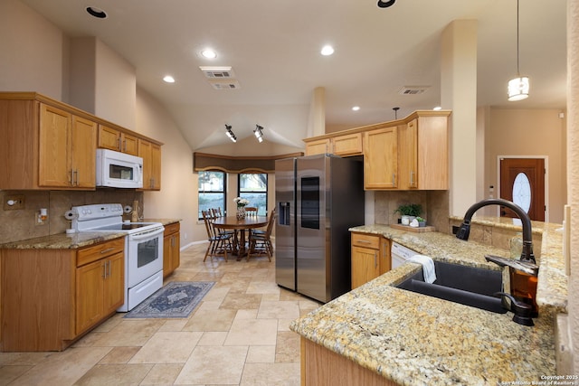 kitchen with pendant lighting, lofted ceiling, backsplash, white appliances, and sink