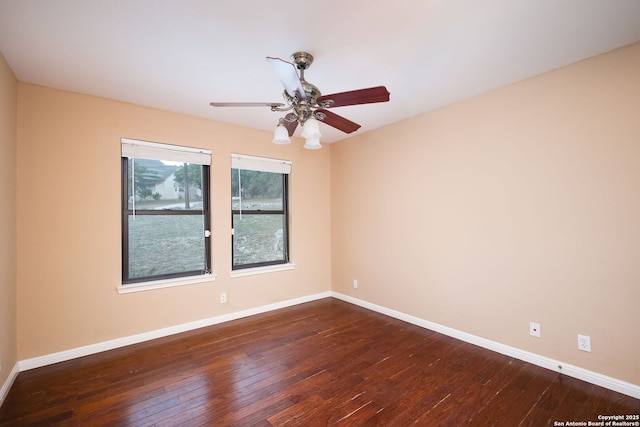 empty room with ceiling fan and dark wood-type flooring