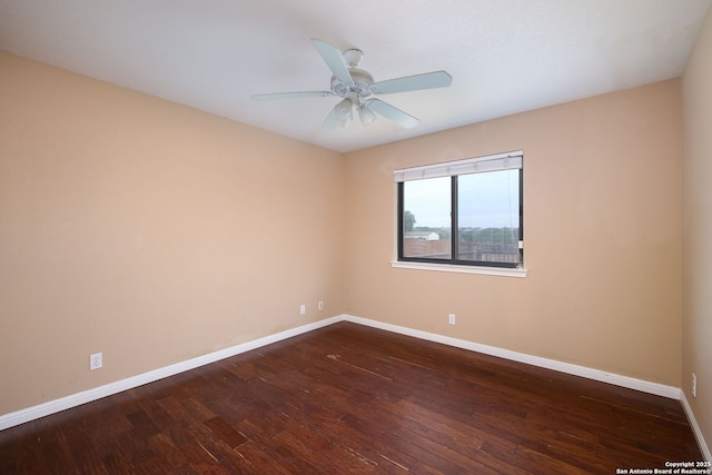 unfurnished room featuring ceiling fan and dark wood-type flooring