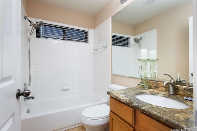 full bathroom with vanity, toilet, and tiled shower / bath