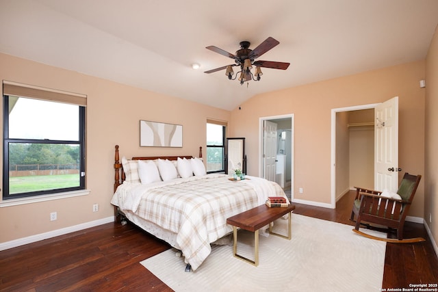 bedroom featuring dark hardwood / wood-style flooring, ensuite bath, vaulted ceiling, ceiling fan, and a closet