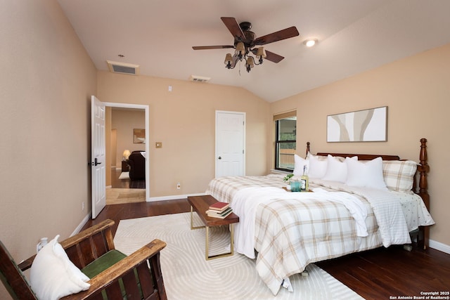 bedroom with ceiling fan, lofted ceiling, and dark wood-type flooring