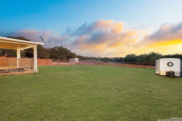 view of yard at dusk