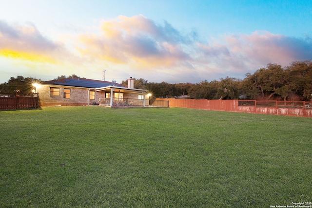 view of yard at dusk