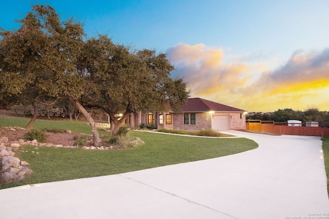 view of front of home with a yard and a garage