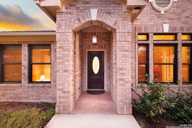 view of exterior entry at dusk