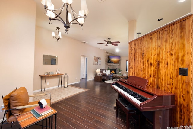 misc room featuring a large fireplace and ceiling fan with notable chandelier