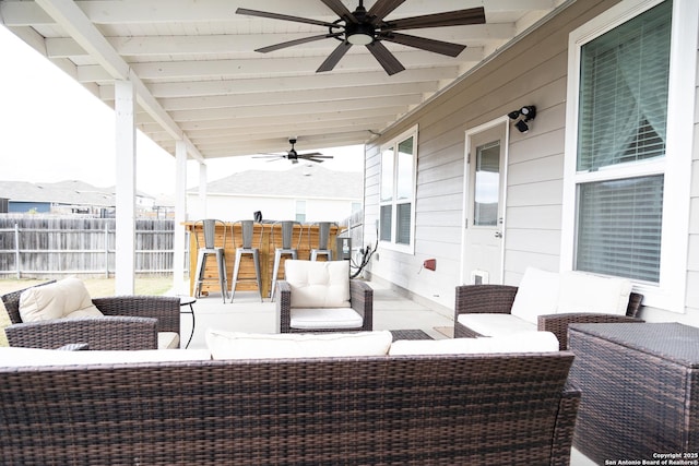 view of patio / terrace with outdoor lounge area, ceiling fan, and exterior bar