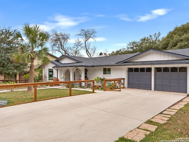 ranch-style house with a front yard and a garage